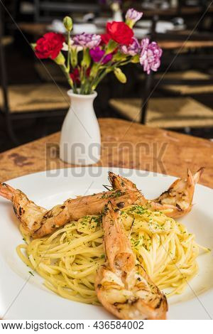 Seafood Spaghetti With Shrimps And Olive Oil In A Restaurant Terrace