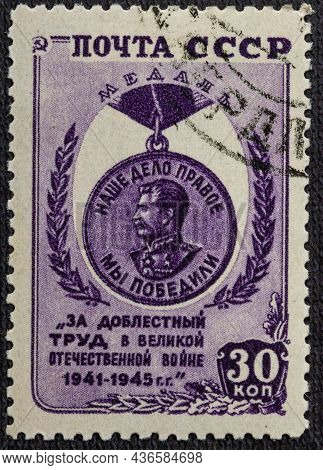 A Stamp Printed In The Ussr Depicts A Medal For Valiant Labor In The Great Patriotic War Of 1941-194