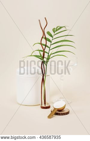 Collagen Powder In A Measuring Spoon With Glass Of Whater And Palm Leaf