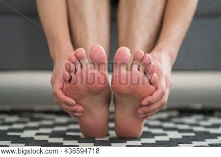 Foot Pain, Man Suffering From Feet Ache At Home
