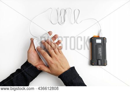 Hands Hold Heating Plate Portable Usb Heater Connected To Power Bank, On White Background