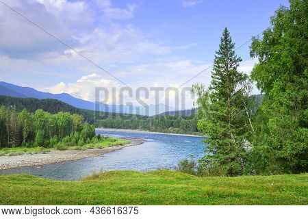 The Bend Of The Riverbed Against The Background Of Mountains Under A Blue Cloudy Sky In Summer. Sibe