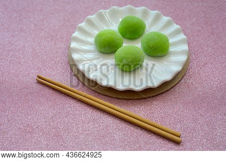 Japanese Dessert With Malaysian Fusion, Pandan Mochi In Green Colour On A White Plate With Chopstick