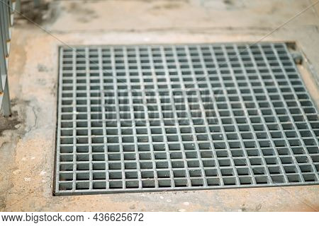 Closeup Drain Sump And Grating On The Floor In Outdoor.