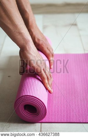 Close-up Image Of A Mans Hands Unrolling The Sports Mat Preparing To Do A Productive Workout. Man Ha