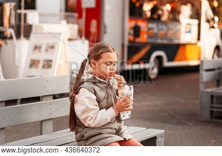 Little Girl Eating Rench Fries With Sauce At Street Cafe Outside. Concept Of Fast Food And Children.