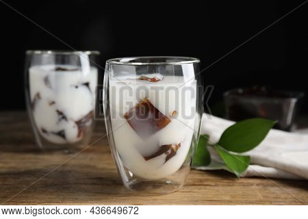 Glasses Of Milk With Delicious Grass Jelly On Wooden Table