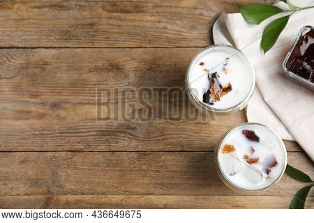 Glasses Of Milk With Delicious Grass Jelly On Wooden Table, Flat Lay. Space For Text