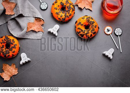 Pumpkin And Chocolate Doughnuts, Halloween Lollipops And Marshmallows On Dark Gray - Halloween Candy
