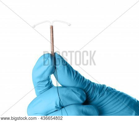 Gynecologist Holding Copper Intrauterine Contraceptive Device On White Background, Closeup