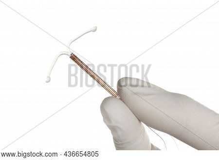 Gynecologist Holding Copper Intrauterine Contraceptive Device On White Background, Closeup