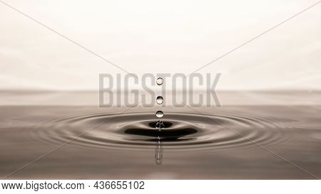Frozen Image Of Clear Water Droplets Splashing With Light Gray Color