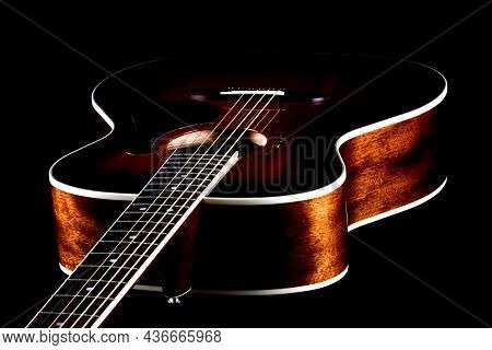 Oblique View Of Mahogany Acoustic Guitar On Black
