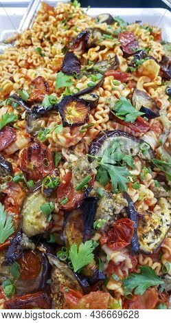 Pasta Colorfully Prepared In The Vegetarian Or Vegan Tradition. With Egg Plant, Sundried Tomotoes, C