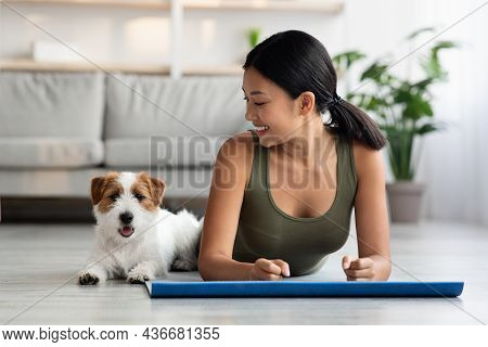 Sporty Korean Lady Enjoying Morning Yoga With Her Doggo