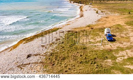 Aerial View, Coastal Landscape With Caravan Trailer Wild Camping On Beach Sea Shore. Mediterranean C