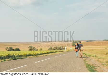Hitchhiking. Thumb Up. Young Brunette Girl In A Denim Jumpsuit Is Hitchhiking Around Country. Free S