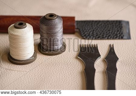 Shoemaker Tools For Sewing Handmade Shoes In Workshop. Punches, Spools Of Thread And Craft Knife Lay