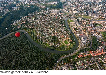 Vilnius, Lithuania - September 14, 2021: Vibrant Red Hot Air Balloon Flying Above Vilnius Capital Of