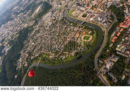 Vilnius, Lithuania - September 14, 2021: Vibrant Red Hot Air Balloon Flying Above Vilnius Capital Of