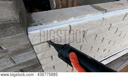 The Process Of Hammering In The Seams In The Facade Of The Tiles. Grouting The Seam On The Facade Of