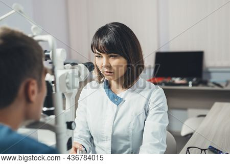Doctor Checks The Vision Of A Young Man. Hospital, Clinic, Medical Examination. Vision Tests At Hosp