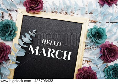 Hello March Typography Text And Flower Dcoration On Blackboard Background