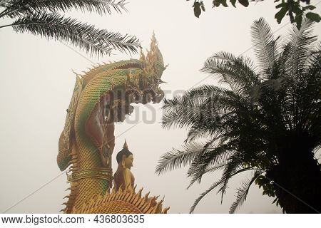 Sakon Nakhon,thailand - October 1 , 2020 : A Large Golden Seated Buddha Statue Outdoors, Sheltered B