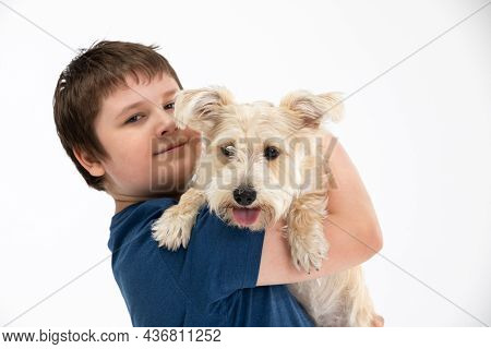 Young Boy Holds His Dog In His Arms. Subject Isolated From The Background.