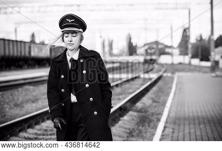 European Or American Train Conductor Is On His Duty On A Platform And Other Trains. Railway, Steam T