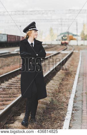European Or American Train Conductor Is On His Duty On A Platform And Other Trains. Railway, Steam T