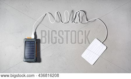 Portable Heater Is Connected By Wire With Usb To Connector Power Bank With Solar Panel On Gray Textu