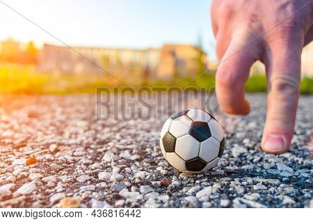 Man Playing Minifootball With His Hands With A Small Ball On The Street