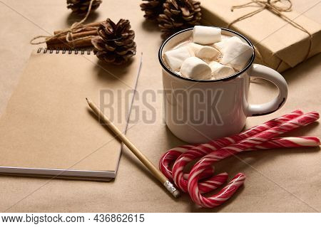 Christmas Composition With Gift In Craft Wrapping Paper, Cinnamon Tied With Rope, Pine Cones, Wooden