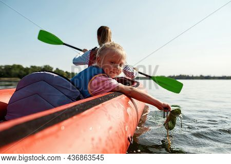 Young Caucasian Family Floating On Kayak Concept Of Rest, Leisure And Vacation At Nature. Extreme Wa