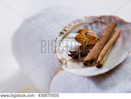 Close up of aromatic spices placed on the rolled towel in the spa. Soothing herbal ingredients for beauty bath and spa treatment.