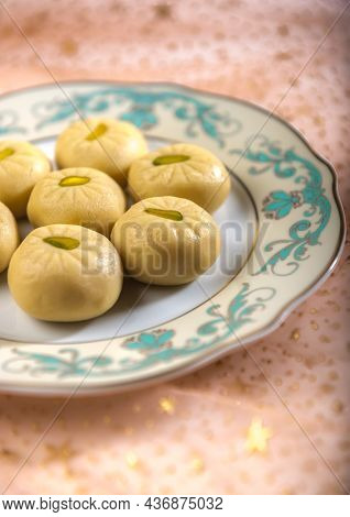 Close up of Pedha, a popular Indian sweet made with condenced milk. Selective focus treatment food photography.
