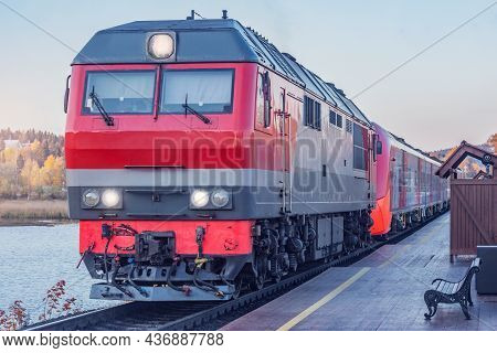 Highspeed Train Stands By The Wooden Platform At Sunset. Sortavala. Republic Of Karelia. Russia.