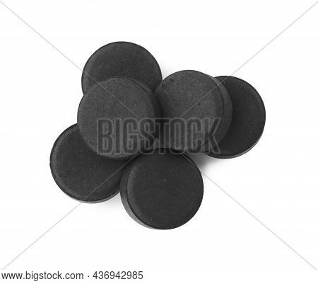 Activated Charcoal Pills On White Background, Top View. Potent Sorbent