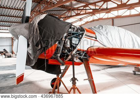 Ultralight small private aircraft airplane on repair in the hangar at the aerodrome airport