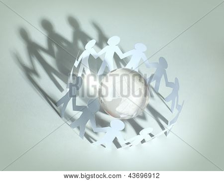 Paper People Standing In A Circle Around Glass Globe