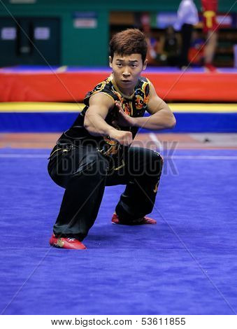 KUALA LUMPUR - NOV 03: Lee Yongmun of South Korea shows his fighting style in the 'nan quan compulsory' event at the 12th World Wushu Championship on November 03, 2013 in Kuala Lumpur, Malaysia.