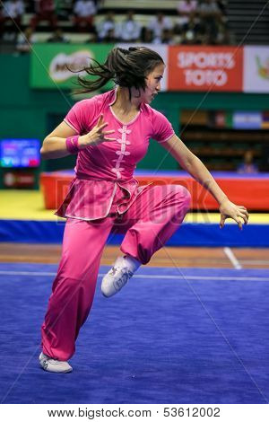 KUALA LUMPUR - NOV 03: Elizabeth Lim of Australia shows her fighting style in the 'Nan quan compulsory' event at the 12th World Wushu Championship on November 03, 2013 in Kuala Lumpur, Malaysia.