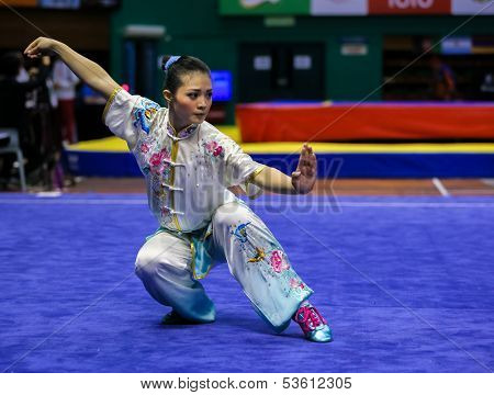 KUALA LUMPUR - NOV 03: Phoon Eyin of Malaysia shows her fighting style in the 'changquan compulsory' event at the 12th World Wushu Championship on November 03, 2013 in Kuala Lumpur, Malaysia.