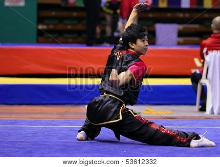 KUALA LUMPUR - NOV 03: Leung Man Chun of Hong Kong shows his fighting style in the 'changquan compulsory' event at the 12th World Wushu Championship on November 03, 2013 in Kuala Lumpur, Malaysia.