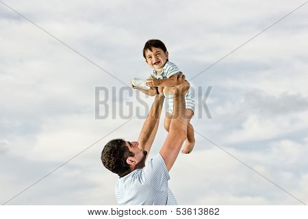 Happy Dad With Baby At The Beach
