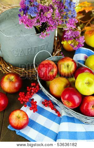 Juicy apples in basket on table close-up