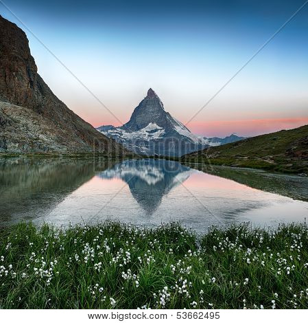 Matterhorn reflection in Riffelsee with flowers, Zermatt, Alps, Switzerland