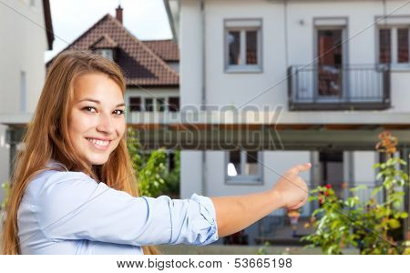 Young woman showing her first home