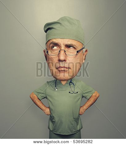 funny picture of bighead pensive doctor in glasses over dark background